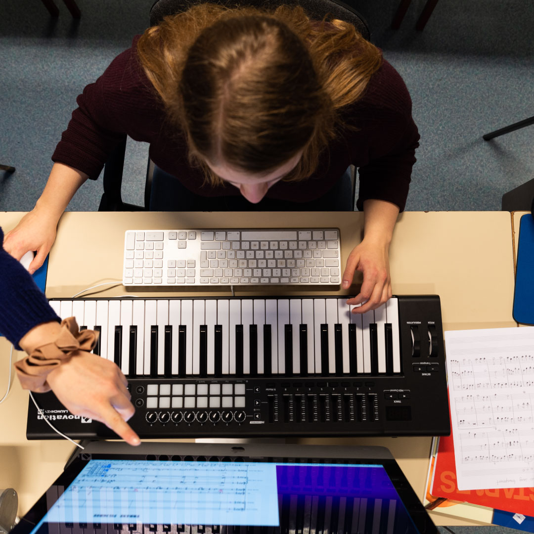 Studentar lagar noteark ved å spele på keyboardet